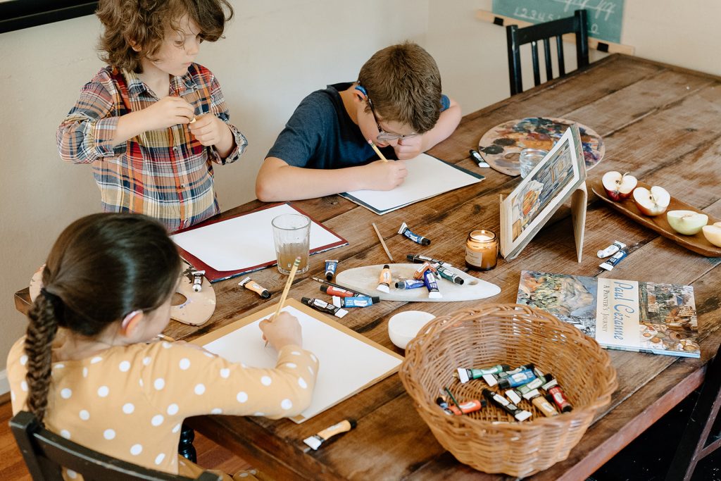 Children using homeschool curriculum materials at table
