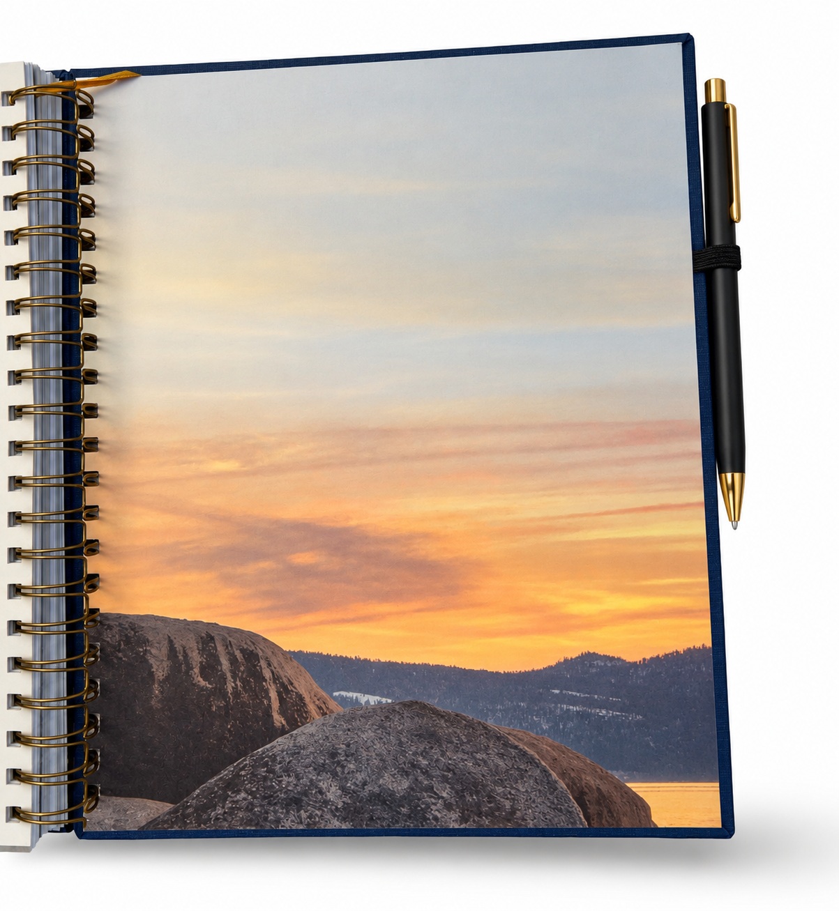Open wire-o hardcover with a black pen held in a pen loop on the back board