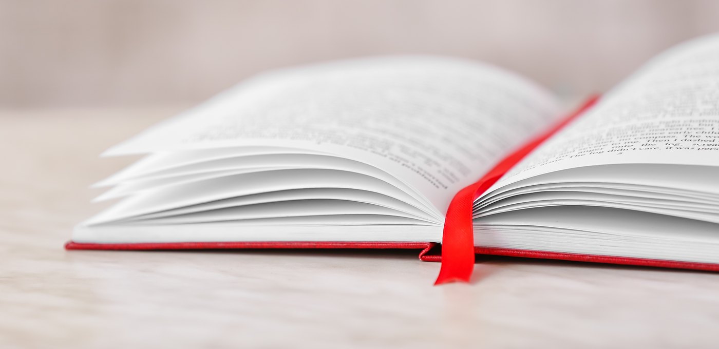 Sewn-in red ribbon marker in an open hardcover book