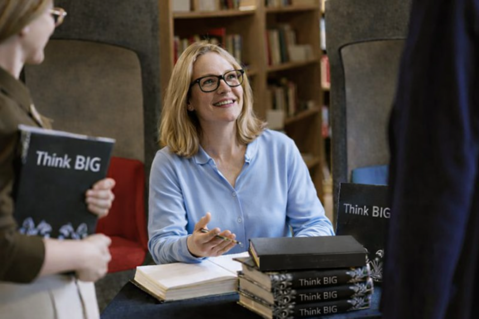 Author signing books at an event